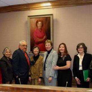 Retired Senator Sheila Kuehl, Retired Senate President pro Tem David Roberti, Retired Assemblymember Patty Berg, Current Senator Lois Wolk, Retired Senator Gloria Romero, and former Senator Rose Ann Vuich staff stand beneath the unveiled portrait of Senator Rose Ann Vuich in the new hearing room named after her at the State Capitol.  Senator Vuich was the first woman Senator and now Room 2040 is the only room in the State Capitol named for a woman.