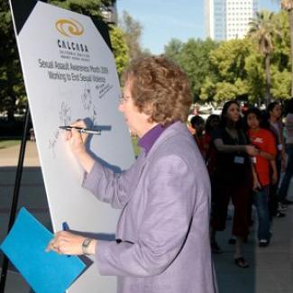 Senator Lois Wolk signs the pledge to end sexual violence against women.